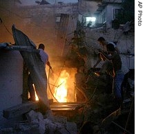 Residents try to extinguish the fire at the site of a Hezbollah rocket attack in the northern Israel a href=