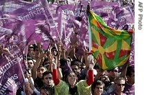 A Turkish Kurd women holds a traditional scarf during during a pre-election rally of the independent candidates in Istanbul, 15 Jul 2007