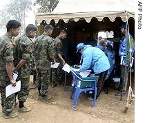 Members of a UN monitoring team observe as Maoist fighters register themselves, during a weapons and personnel a href=