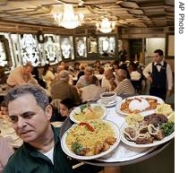 Enrique Martinez carries an order at the Versailles Restaurant in Miami 