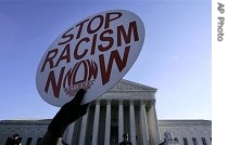 A demonstrator holds up a sign in front of the Supreme Court as court heard arguments on a href=