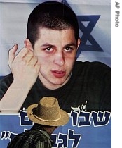 A man looks at a banner of captured Israeli soldier Gilad Shalit placed in protest outside the Prime Minister's office in Jerusalem 