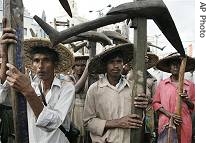 Farmers stand with ploughs during a demonstration against the West Bengal state government's move to use agricultural land for industrialization, in Calcutta, India