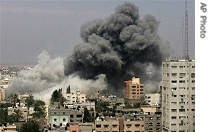 Smoke rises from an explosion following an Israeli airstrike on a building used by the a href=