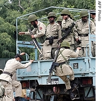 Pakistani paramilitary soldiers get down from a truck beside the a href=