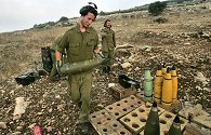 Israeli gunner prepares next shell after a href=
