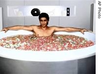 Bollywood actor Shah Rukh Khan is seen lying in a bathtub filled with pink and red rose a href=