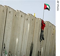 A Palestinian youth climbs the separation barrier during clashes with Israeli troops at the Kalandia Checkpoint between Jerusalem and the West Bank town of Ramallah, 09 a href=