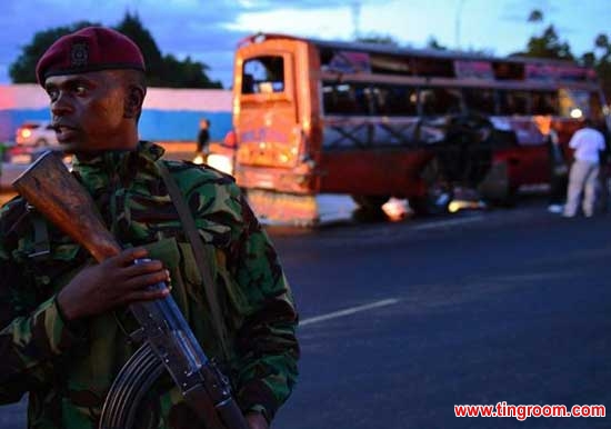 A Kenyan policeman stands in front of the a href=