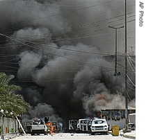 Smoke from burning cars rise after clashes broke out in the streets of Shiite holy city of Karbala, south of Baghdad, Iraq, 28 Aug 2007