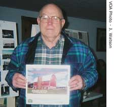 Leo Fitzpatrick holds a picture of his prize-winning barn 